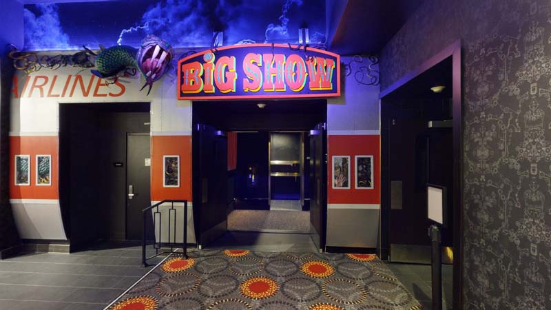 A picture of the big show audio booth. A big sign saying "Big Show" illuminated by neon.